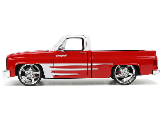 Brand new 1/24 scale diecast car model of 1985 Chevrolet C-10 Pickup Truck Red with White Top and Graphics with Extra Wheels Just Trucks Ser