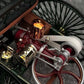 A detailed closeup of the engine in a vintage Mercedes Benz diecast model car