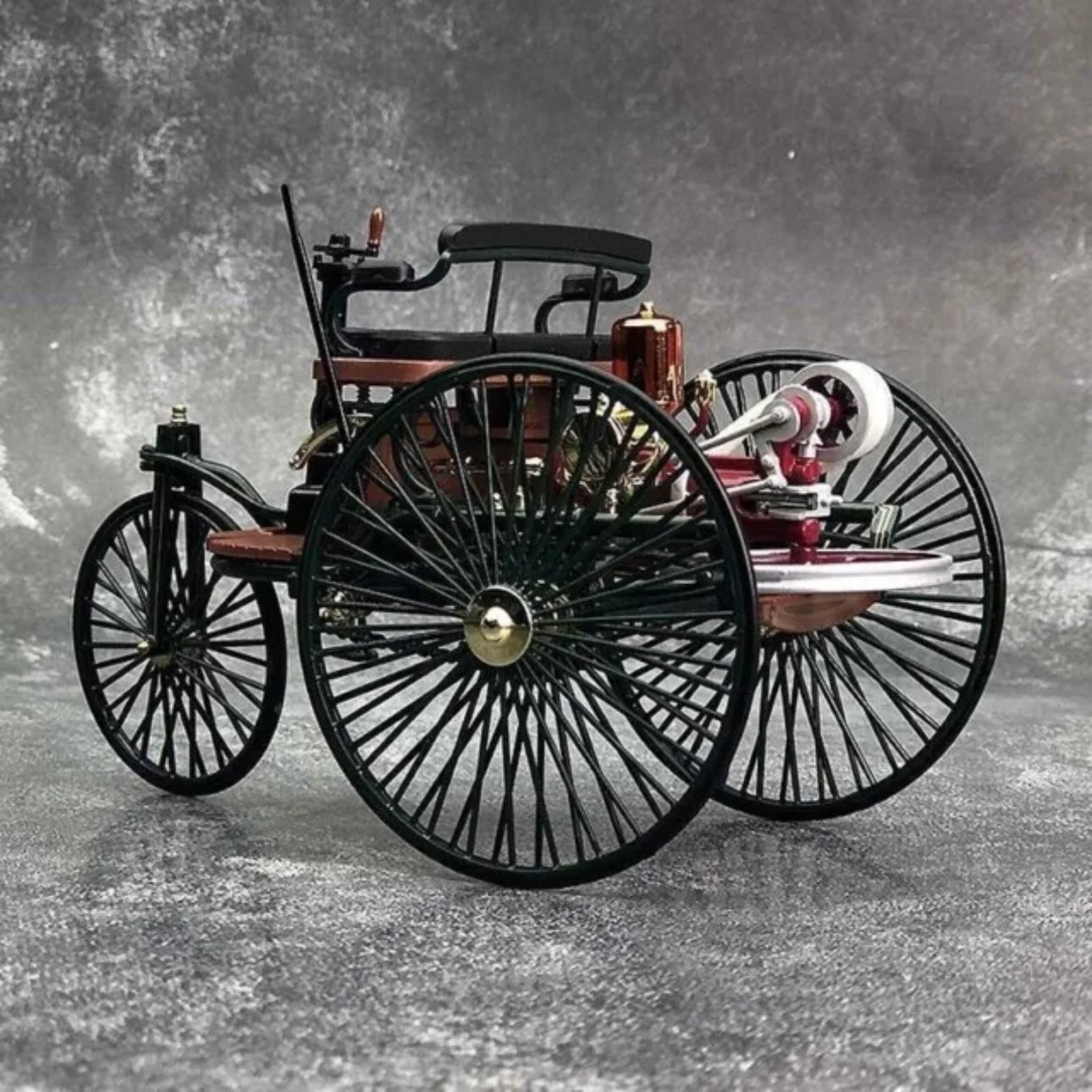 A diecast model miniature replica of an antique Mercedes Benz car