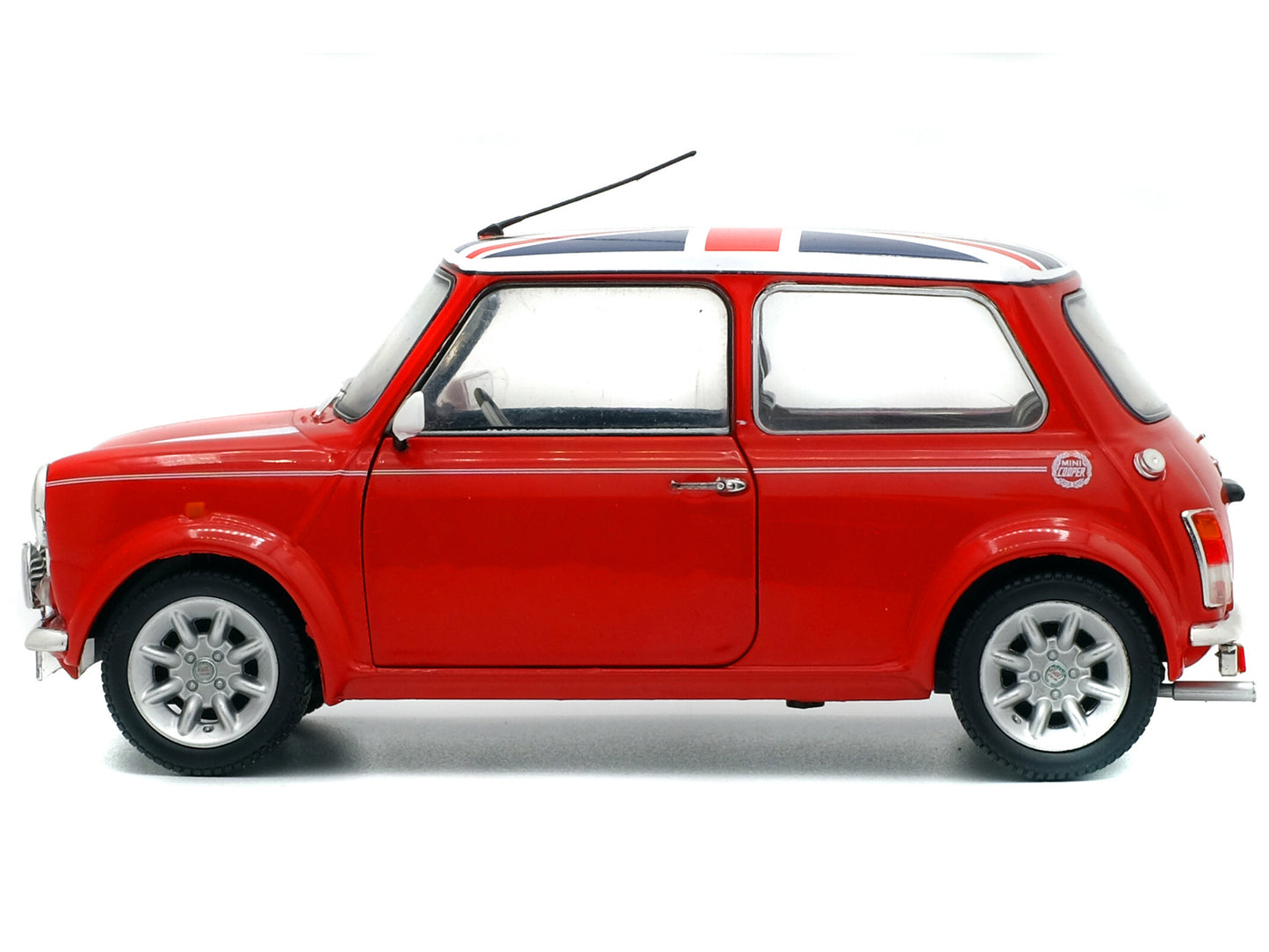 Brand new 1/18 scale diecast car model of Mini Cooper 1.3i Sport Pack Red with White Stripes and UK Flag on Top die cast model car by Solido